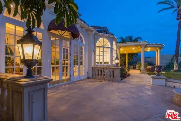 a view of a house with swimming pool and porch