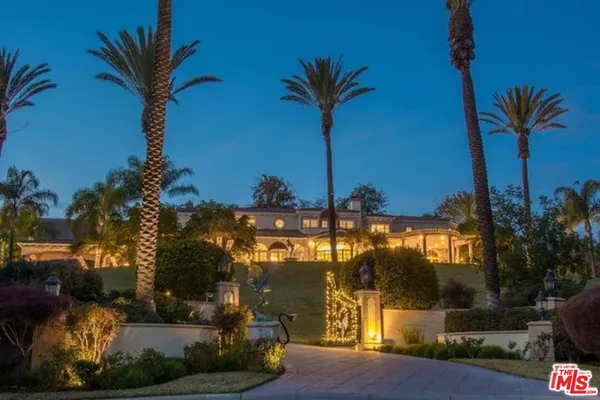 a view of a palm trees in front of a house