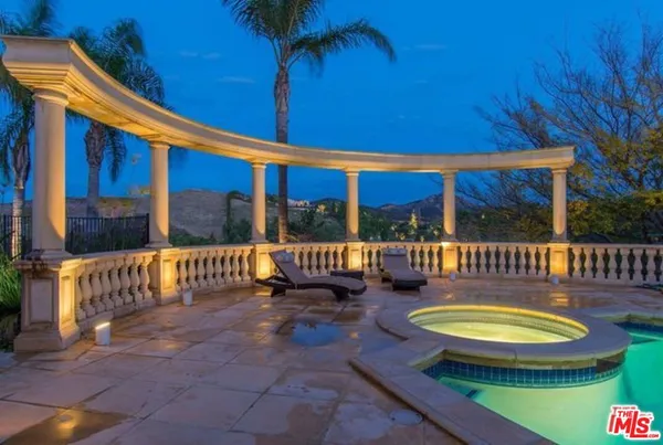 a view of a swimming pool with a patio