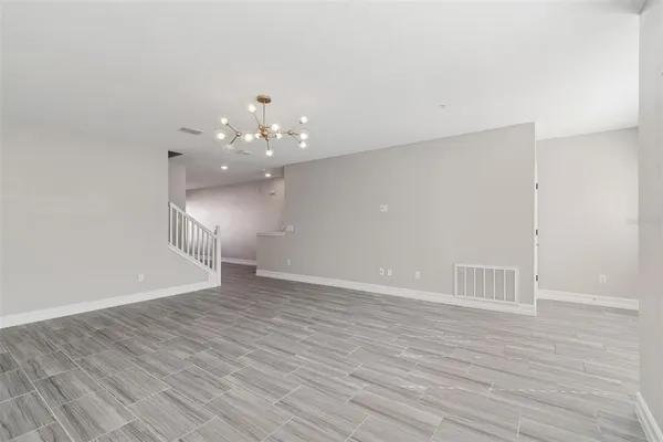a view of a room with wooden floor and window