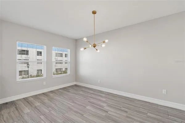 a large kitchen with stainless steel appliances kitchen island granite countertop a sink a stove and a refrigerator