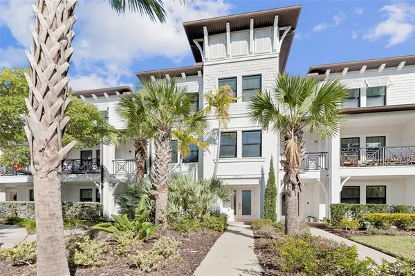a view of a hallway with wooden floor and entryway