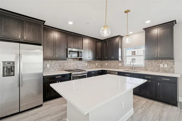a kitchen with a sink cabinets and wooden floor