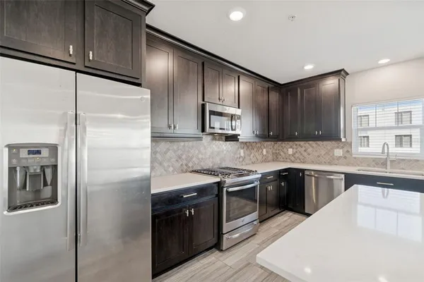 a kitchen with a sink cabinets and a window