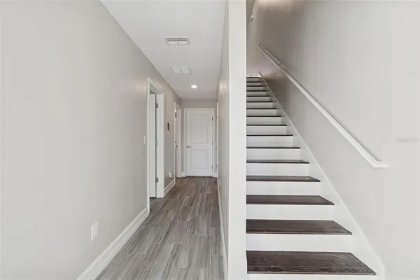 a view of a hallway with wooden floor