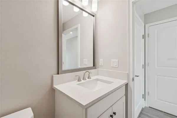 a view of a kitchen with wooden floor and electronic appliances