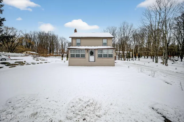 a view of a house with a snow in the yard