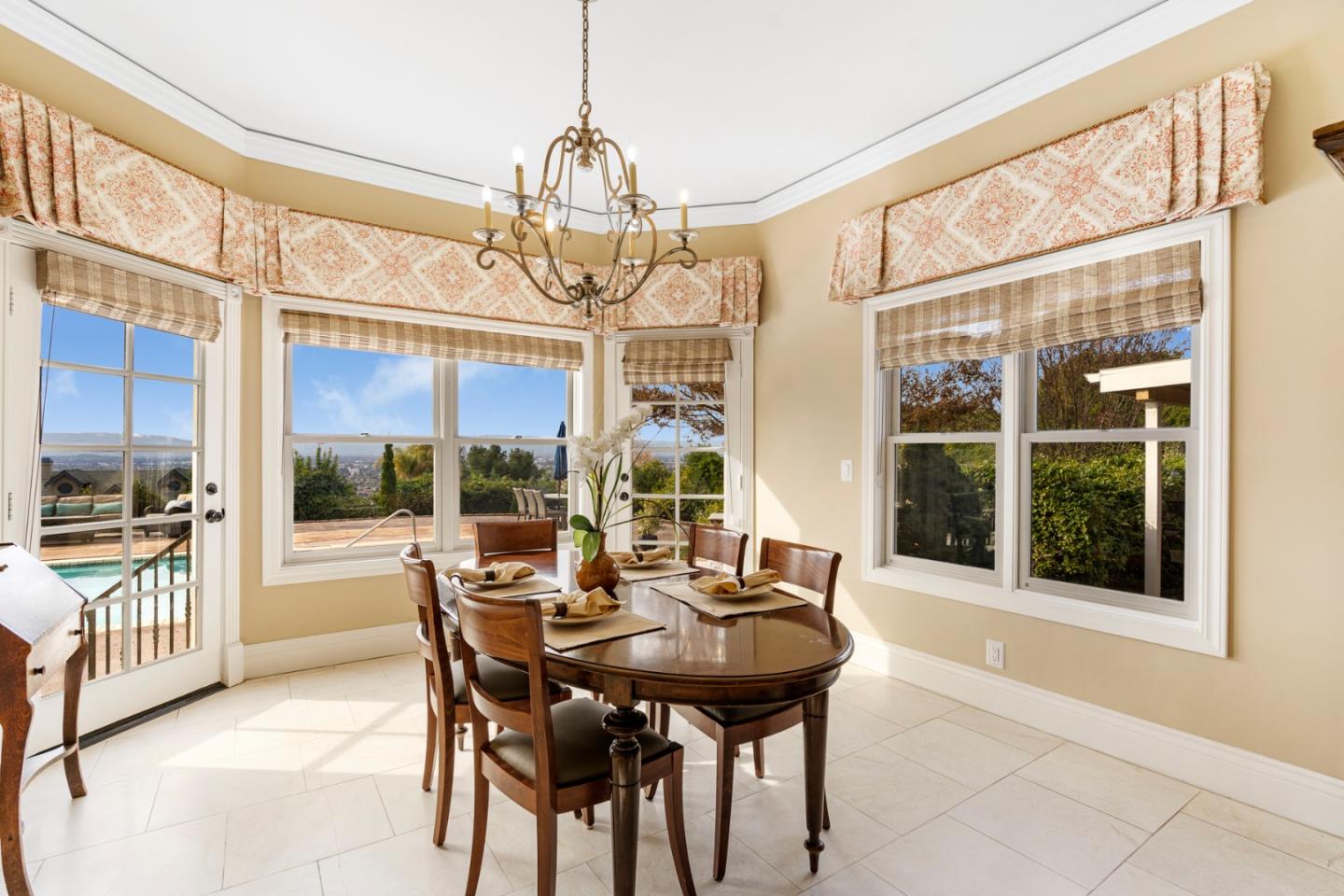 10340 Anderson Road San Jose, CA 95127 - Photo 15 of 65 a view of a dining room with furniture large windows and wooden floor