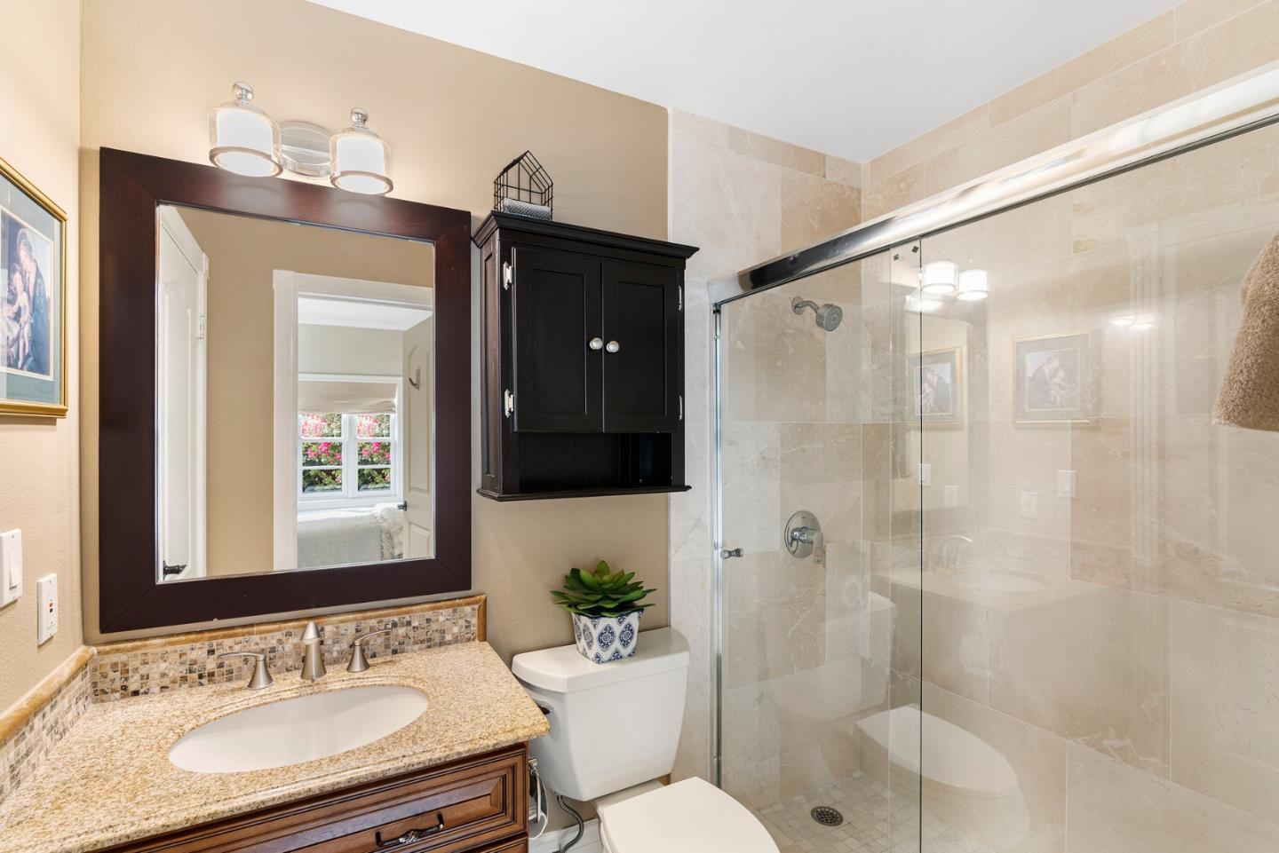 10340 Anderson Road San Jose, CA 95127 - Photo 28 of 65 a bathroom with a shower sink vanity mirror and toilet