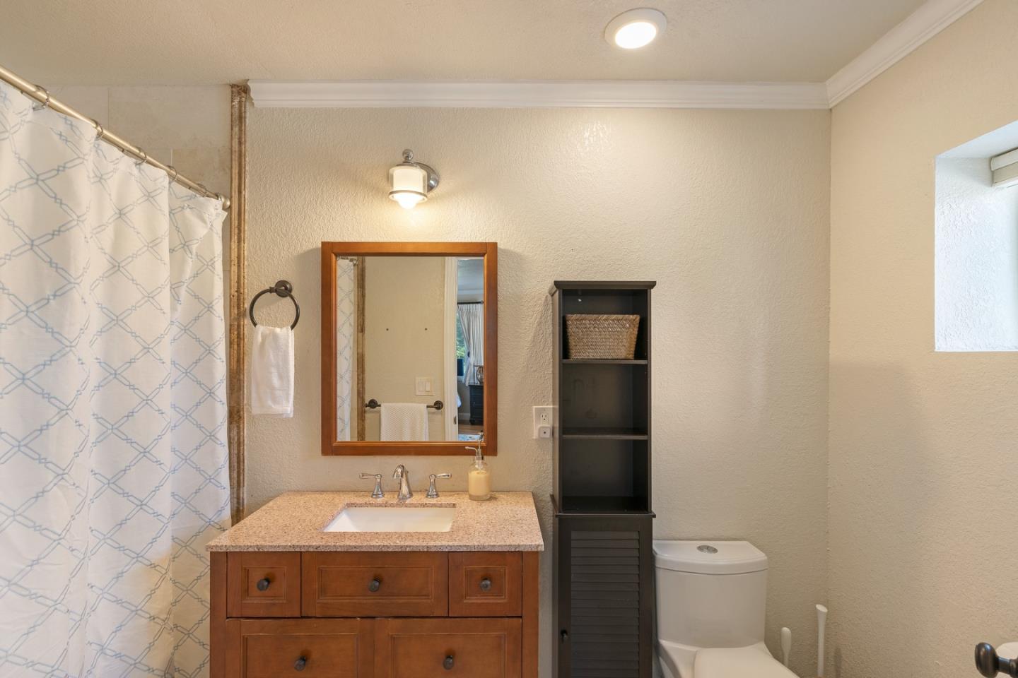 10340 Anderson Road San Jose, CA 95127 - Photo 62 of 65 a bathroom with a sink vanity mirror and toilet