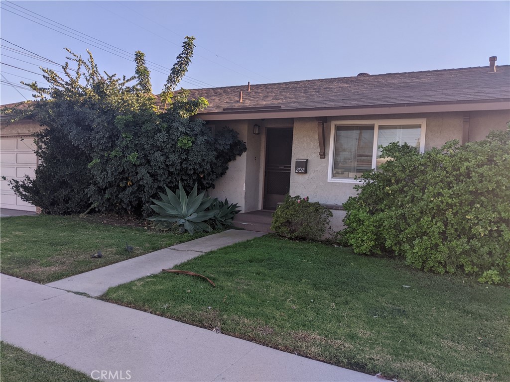 202 South Agate Street Anaheim, CA 92804 - Photo 1 of 15 a front view of a house with a yard