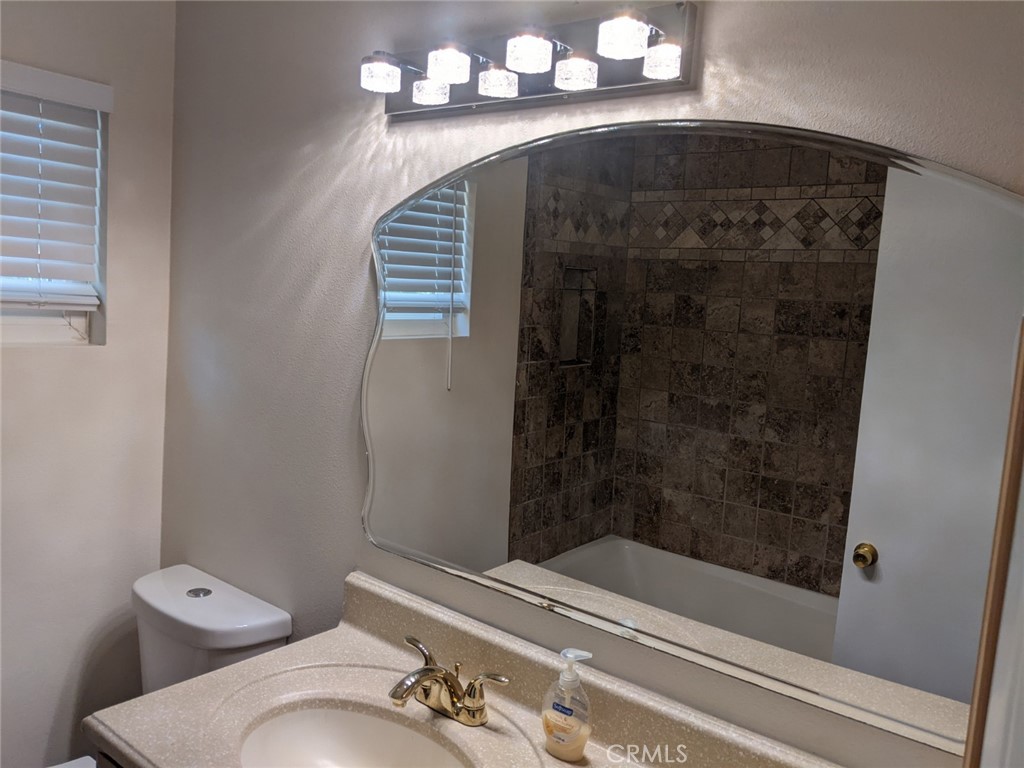 202 South Agate Street Anaheim, CA 92804 - Photo 11 of 15 a bathroom with a sink and a mirror