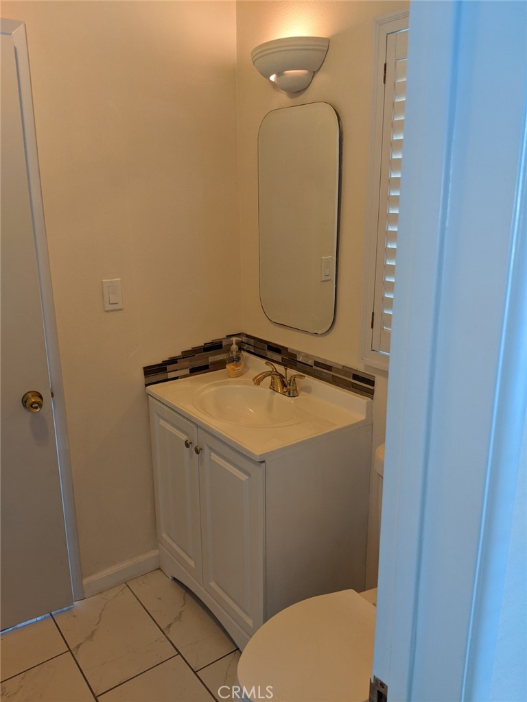 202 South Agate Street Anaheim, CA 92804 - Photo 13 of 15 a bathroom with a sink and a mirror