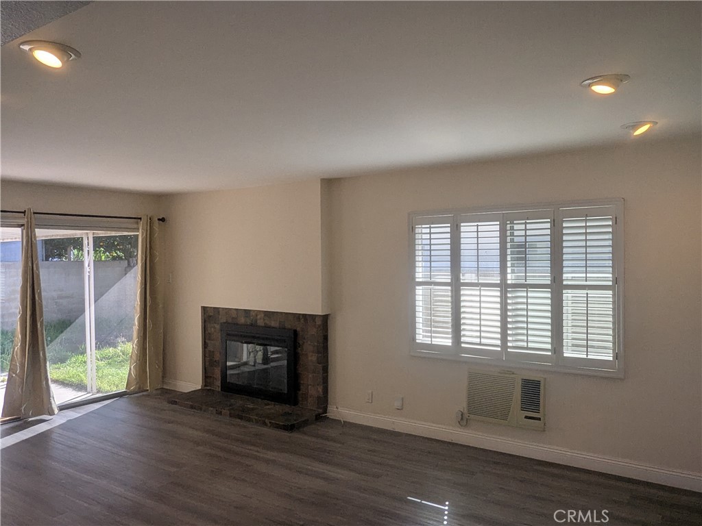 202 South Agate Street Anaheim, CA 92804 - Photo 4 of 15 a view of an empty room with wooden floor and a window