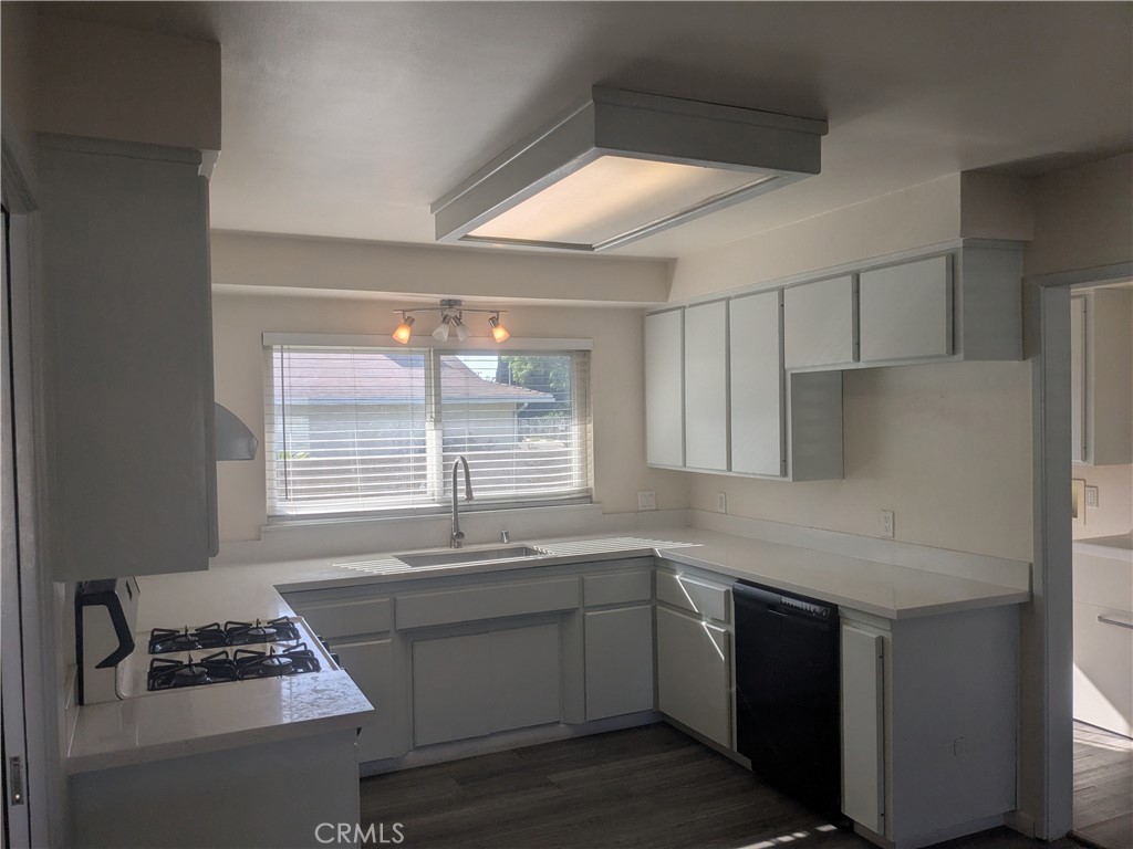 202 South Agate Street Anaheim, CA 92804 - Photo 6 of 15 a kitchen with stainless steel appliances kitchen island a sink stove and cabinets