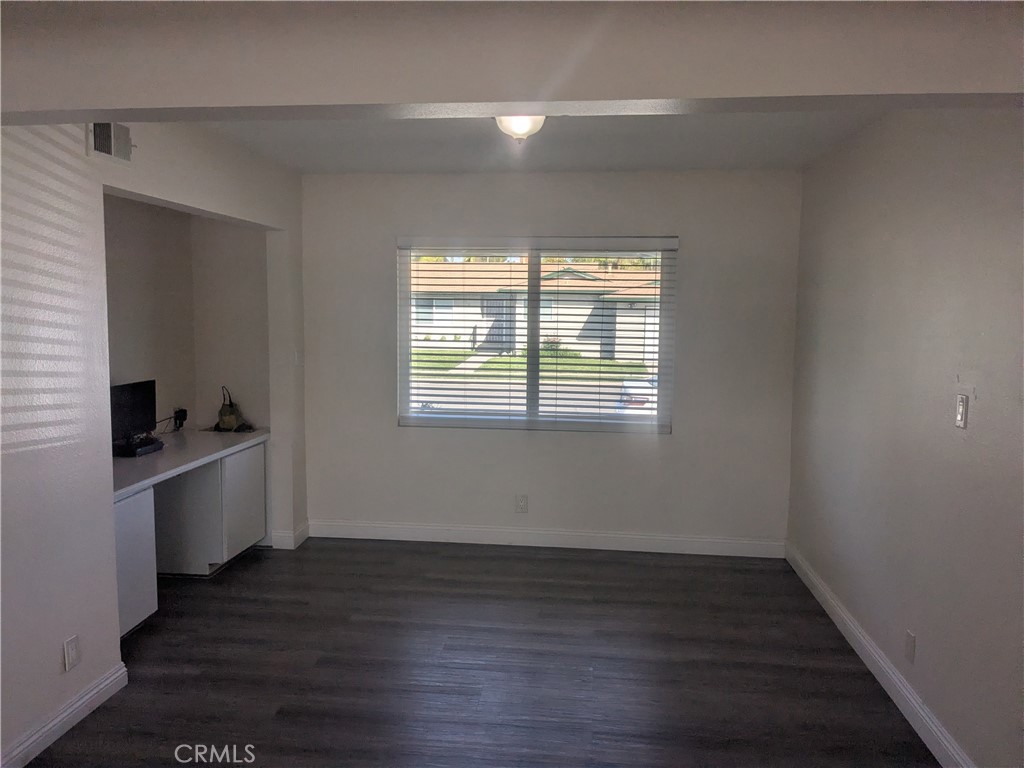 202 South Agate Street Anaheim, CA 92804 - Photo 7 of 15 a view of an empty room with wooden floor and a window