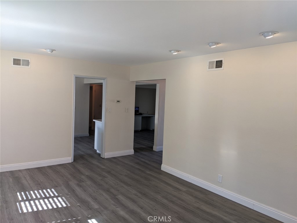 202 South Agate Street Anaheim, CA 92804 - Photo 8 of 15 a view of an empty room with wooden floor and a window