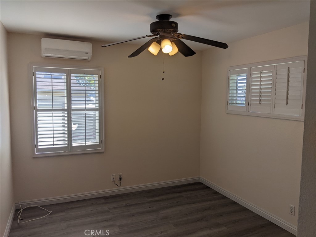 202 South Agate Street Anaheim, CA 92804 - Photo 9 of 15 an empty room with wooden floor and windows