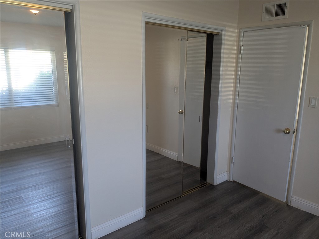 202 South Agate Street Anaheim, CA 92804 - Photo 10 of 15 an empty room with wooden floor and closet