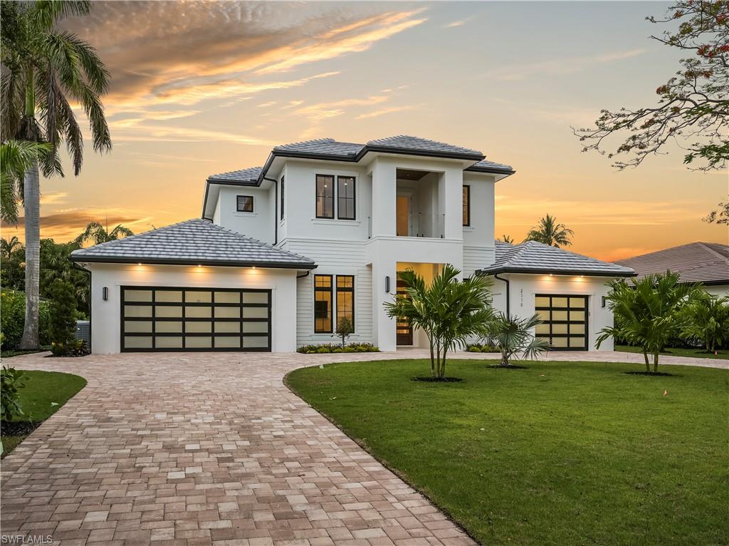 2115 Crayton Road Naples, FL 34102 - Photo 2 of 9 a house view with a garden space