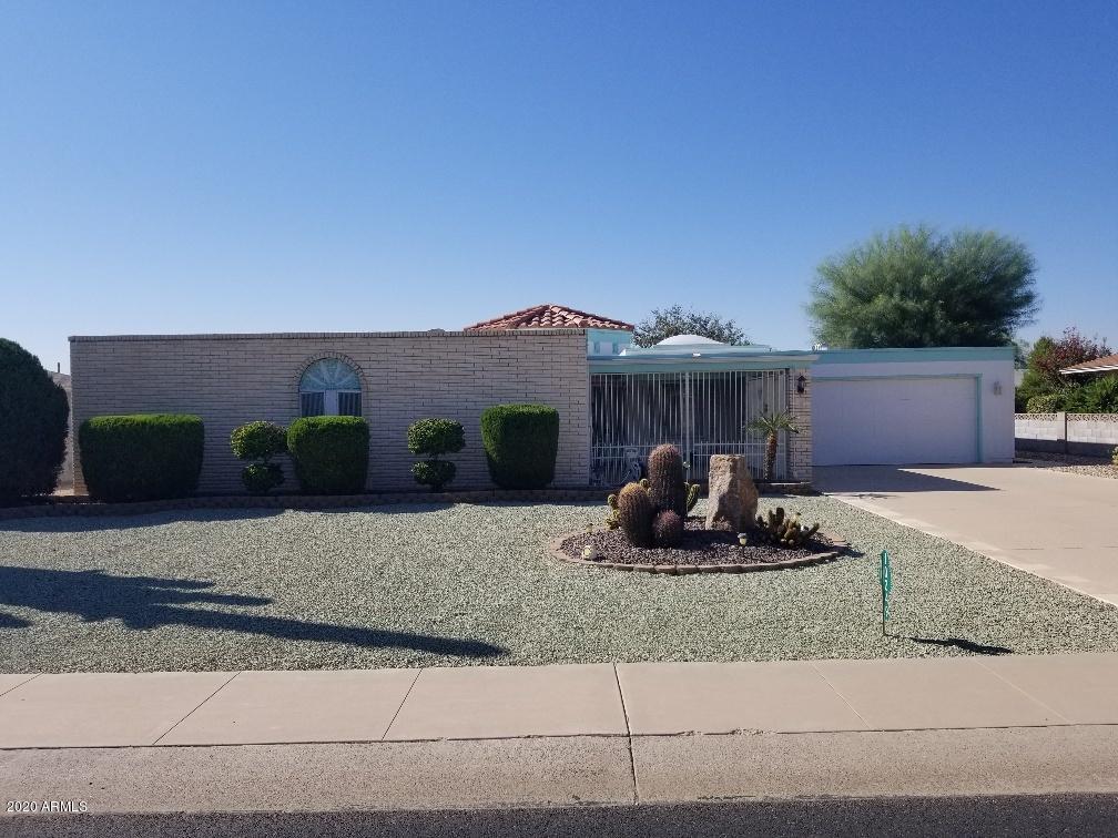 10249 West Burns Drive Sun City, AZ 85351 - Photo 2 of 30 a front view of a house with a yard and garage