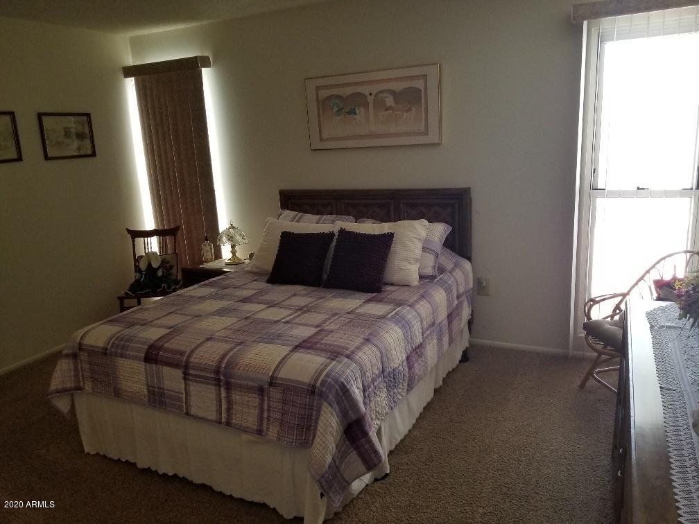 10249 West Burns Drive Sun City, AZ 85351 - Photo 21 of 30 a bedroom with a bed and a window