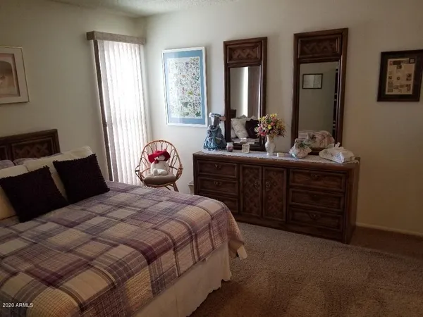 a bedroom with a bed and a dresser
