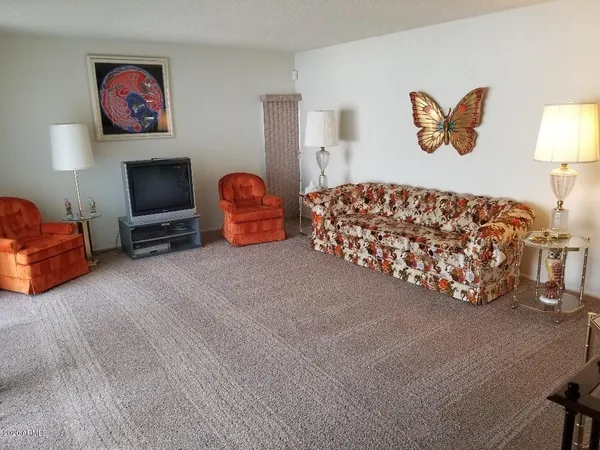 a bed room with furniture and a flat screen tv