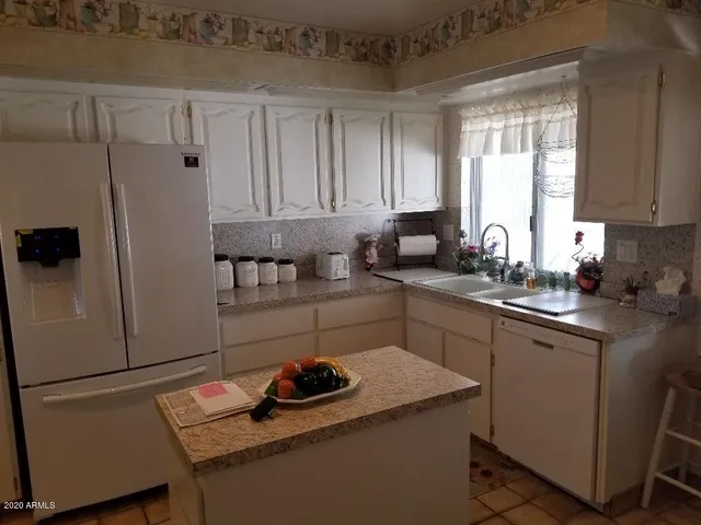 a kitchen with a sink stove and refrigerator