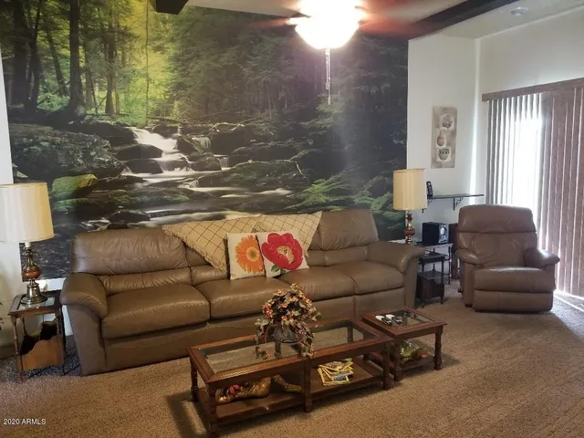 a living room with furniture and a floor to ceiling window