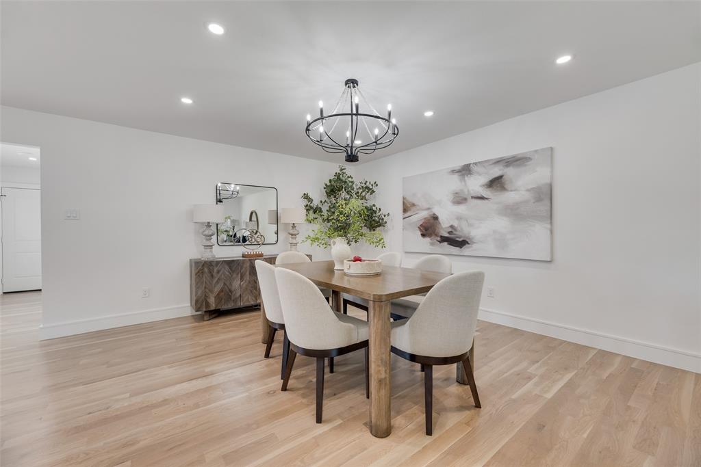9662 Angleridge Road Dallas, TX 75238 - Photo 14 of 30 a view of a dining room with furniture wooden floor and a chandelier