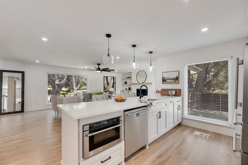 9662 Angleridge Road Dallas, TX 75238 - Photo 17 of 30 a kitchen with a sink stove and wooden floor