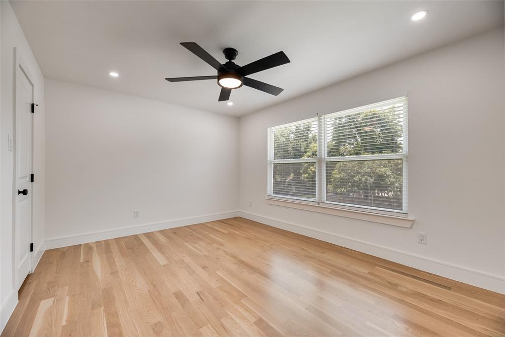 9662 Angleridge Road Dallas, TX 75238 - Photo 23 of 30 an empty room with a window and a ceiling fan