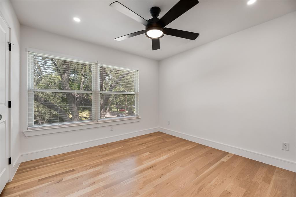 9662 Angleridge Road Dallas, TX 75238 - Photo 24 of 30 an empty room with a window and a fan