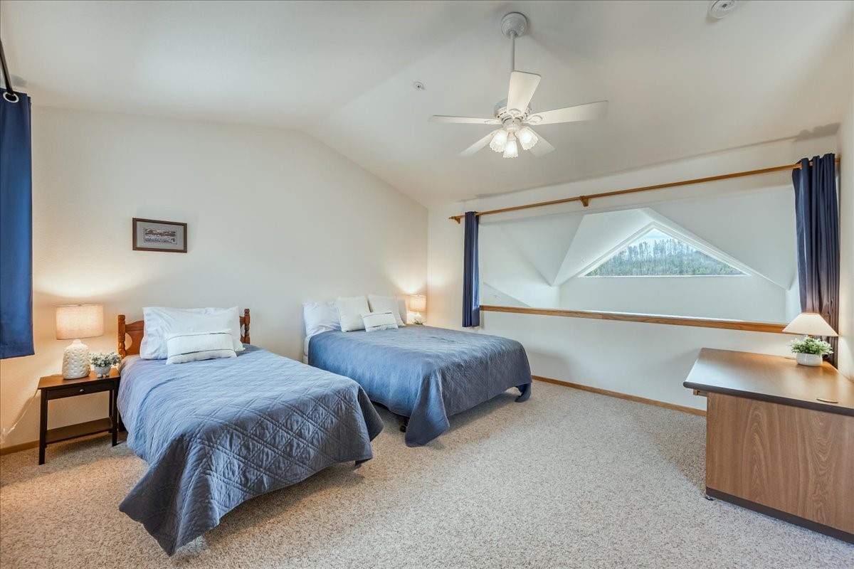91399 Ryan Gulch Road, Unit B6 Silverthorne, CO 80498 - Photo 21 of 36 a bedroom with two beds and a dresser