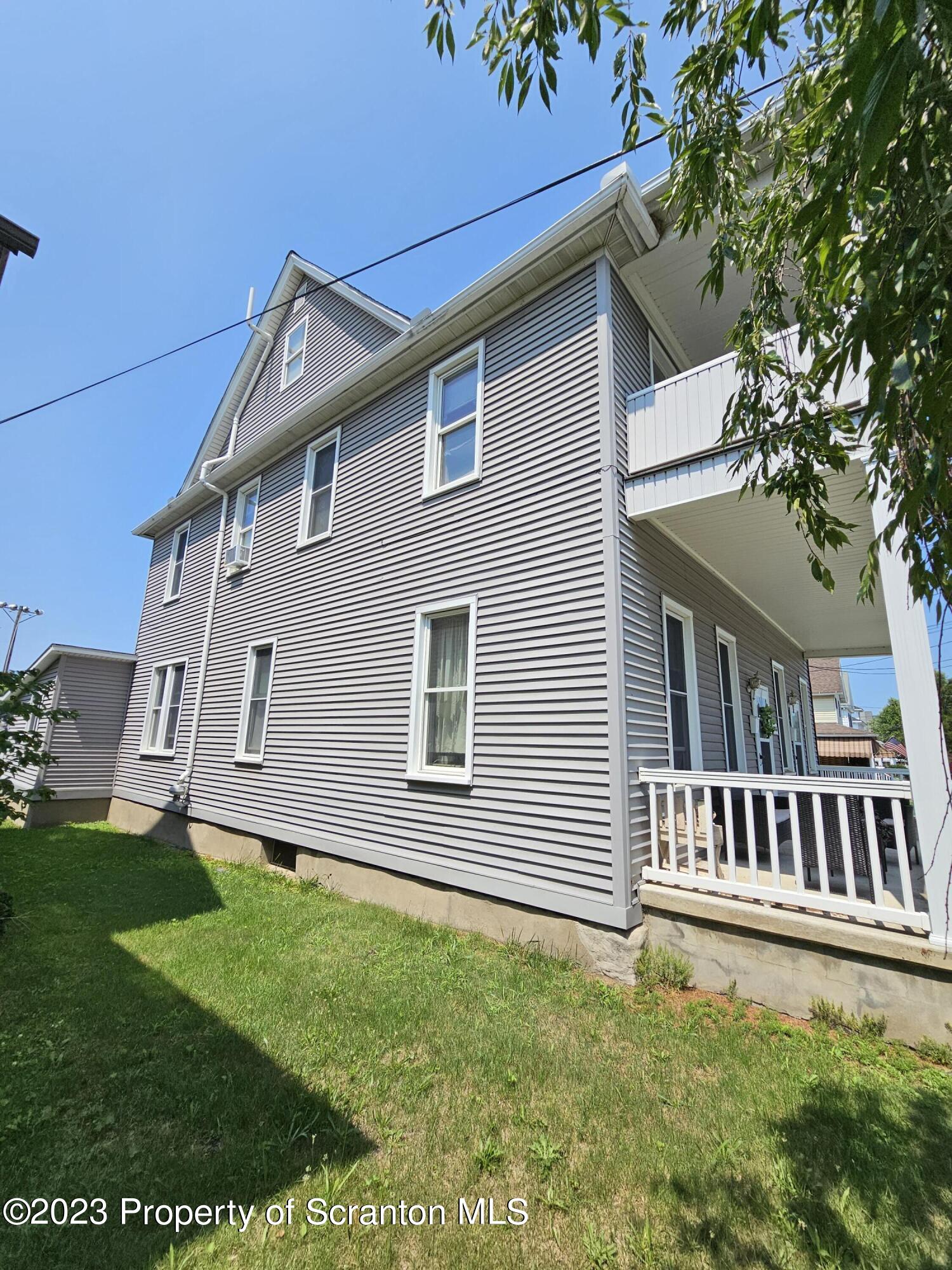 226 Spring Street Moosic, PA 18507 - Photo 2 of 25 a front view of a house with a garden