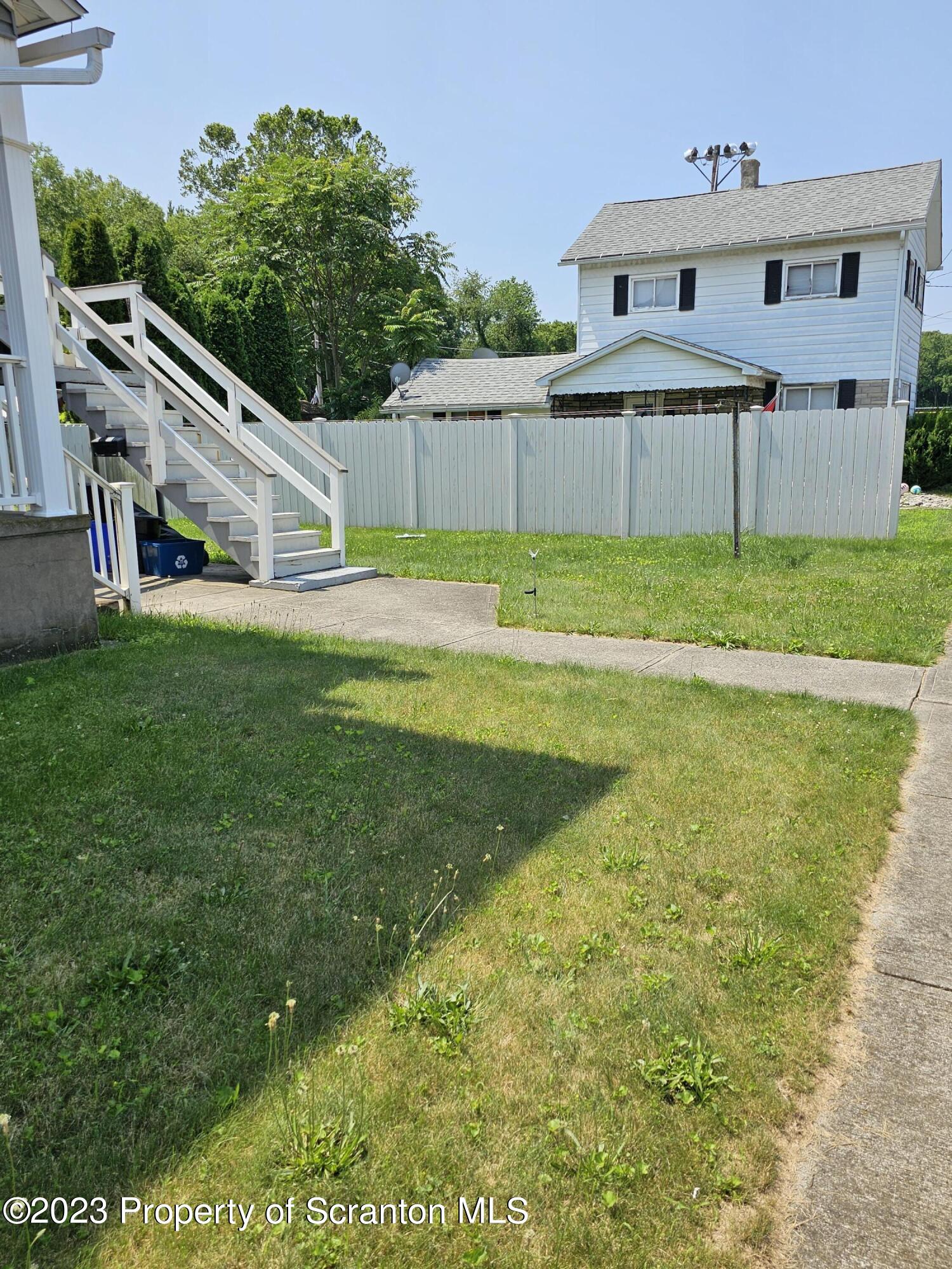 226 Spring Street Moosic, PA 18507 - Photo 5 of 25 a front view of a house with a yard