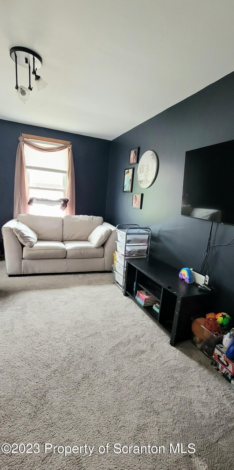 226 Spring Street Moosic, PA 18507 - Photo 6 of 25 a living room with furniture and a flat screen tv