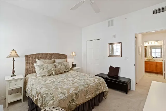 a bathroom with a toilet a sink a mirror a bathtub and vanity