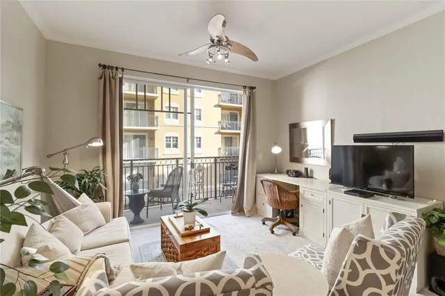 a living room with furniture flowerpot and wooden floor
