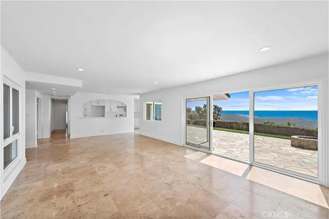 an empty room with sliding glass door and door