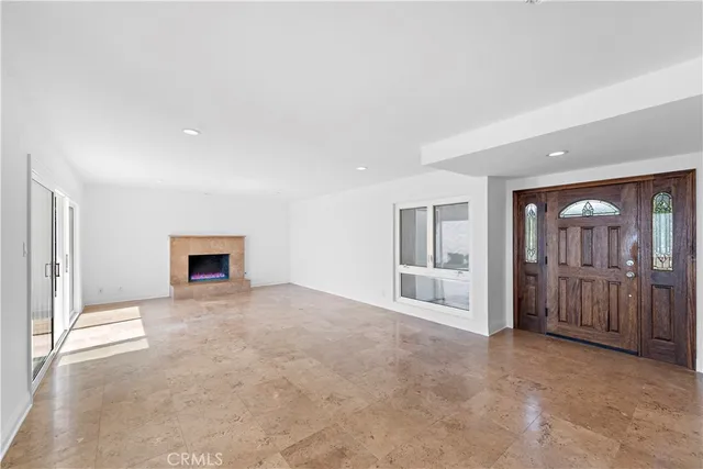 an empty room with windows and cabinet