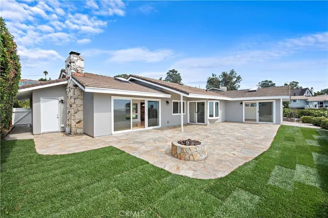 a front view of a house with a garden and yard