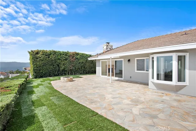 a view of white house with a yard