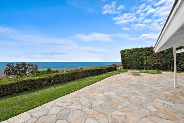 a view of a garden with a building in the background