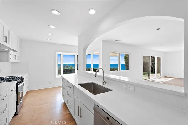 a kitchen with counter top space and windows