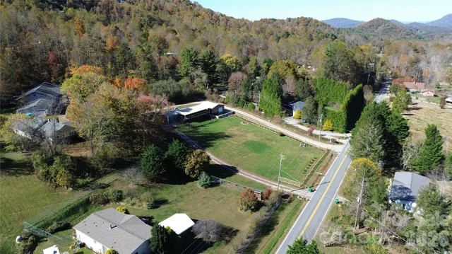 an aerial view of a house with a yard