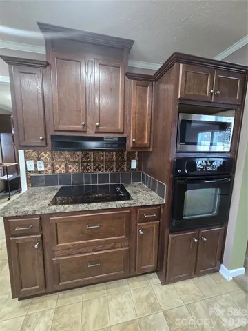 a large kitchen with a large counter top appliances and cabinets