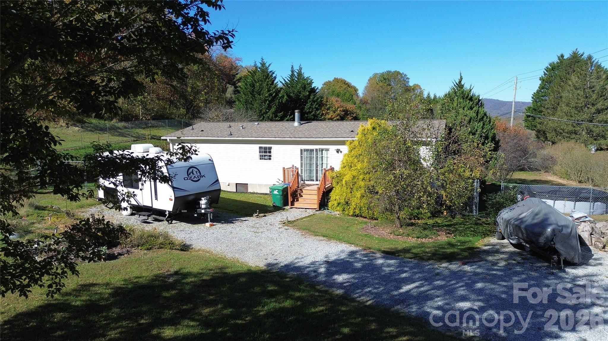 703 Garren Creek Road Fairview, NC 28730 - Photo 2 of 48 a front view of a house with a yard and garage