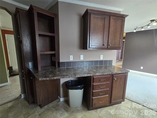 a view of empty room with window and fireplace